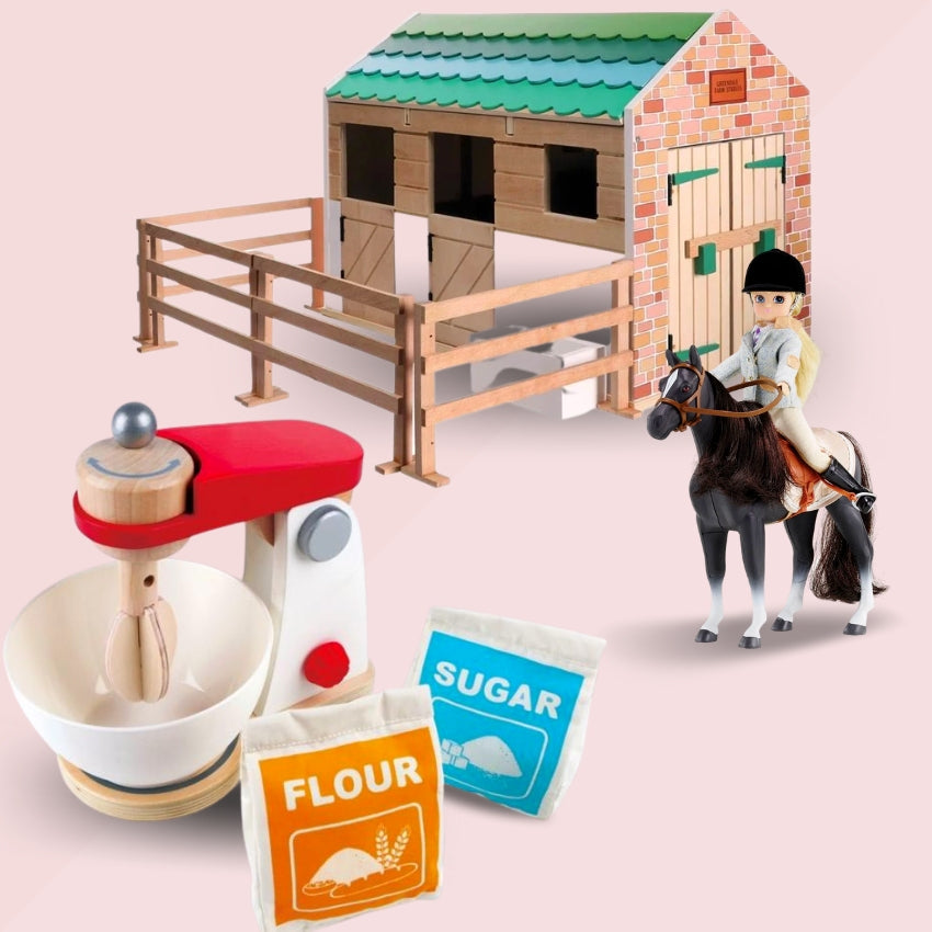 Toy kitchen mixer with bags of 'flour' and 'sugar' and a Horse, rider and stables back right.