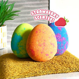 3 colourful bath bombs with the wording 'strawberry scented'.