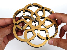 Hands playing the Wooden Maze puzzle from Constantin.