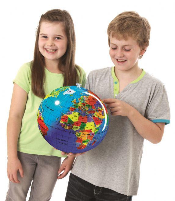 Girl and boy looking at an inflated globe.