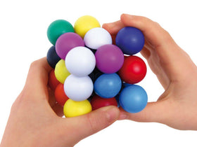 Hands lifting one of the sliding wooden slats to release the ball from the Hidden Corridor puzzle.