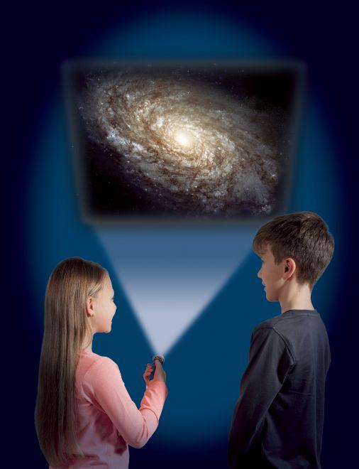 Girl and boy using the torch to project an image of the milky way onto a wall.