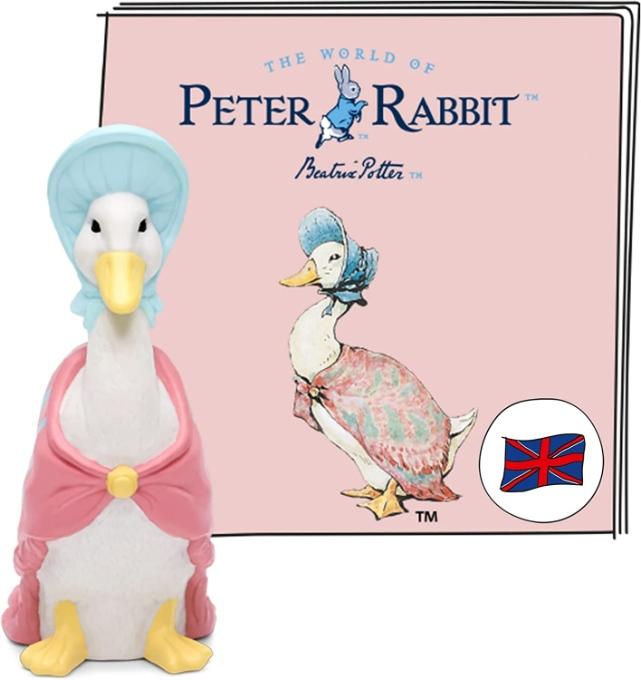 White Jemima Puddleduck figure wearing a pink cape and blue bonnet. Standing in front of the Tonie booklet for the Jemima Puddleduck story.