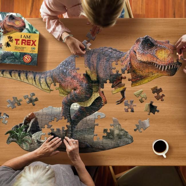 Image from above of people placing pieces of the large T Rex jigsaw.