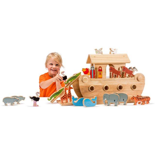 Child playing with wooden Noahs's Ark and colourful, wooden creatures.