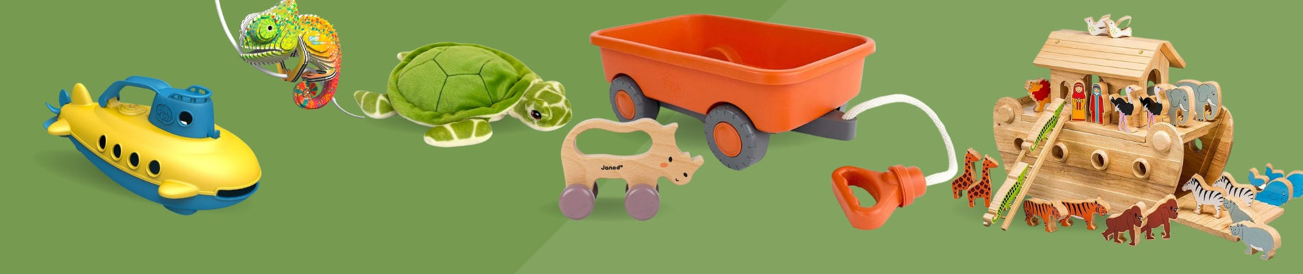 A collection of eco-friendly toys including a recycled plastic submarine, card chameleon model, a cuddly turtle, orange cart and wooden Noah's Ark.