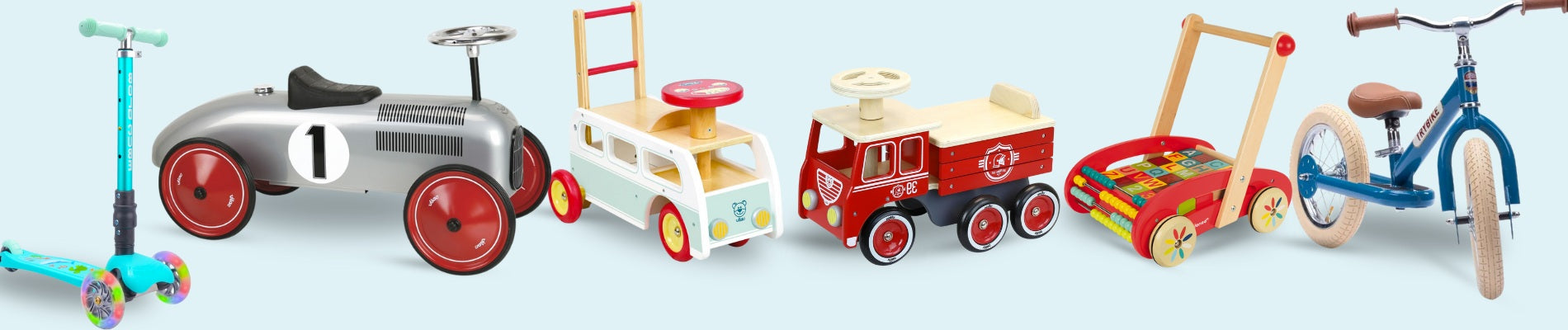A collection of children's ride-on and push-along toys including (l-r) a scooter, metal retro car and a balance bike. 
