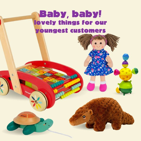 Text in purple that reads:"Baby, baby! lovely things for our youngest customers" with images of a rag-doll, wooden trolley with blocks and a pull-along wooden turtle.