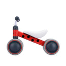 The Baby Balance Bike - Betty Ladybird by Boldcube is a small red ride-on with a white seat and gray wheels. Its frame features black accents resembling a ladybug pattern, making it an ideal jungle-themed first birthday gift.