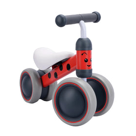 The Boldcube Baby Balance Bike - Betty Ladybird is a delightful red tricycle for toddlers featuring smiley faces on the handlebars, four grey wheels, a white seat, and black accents. Its cartoonish design makes it perfect as a baby bike or jungle-themed first birthday gift.