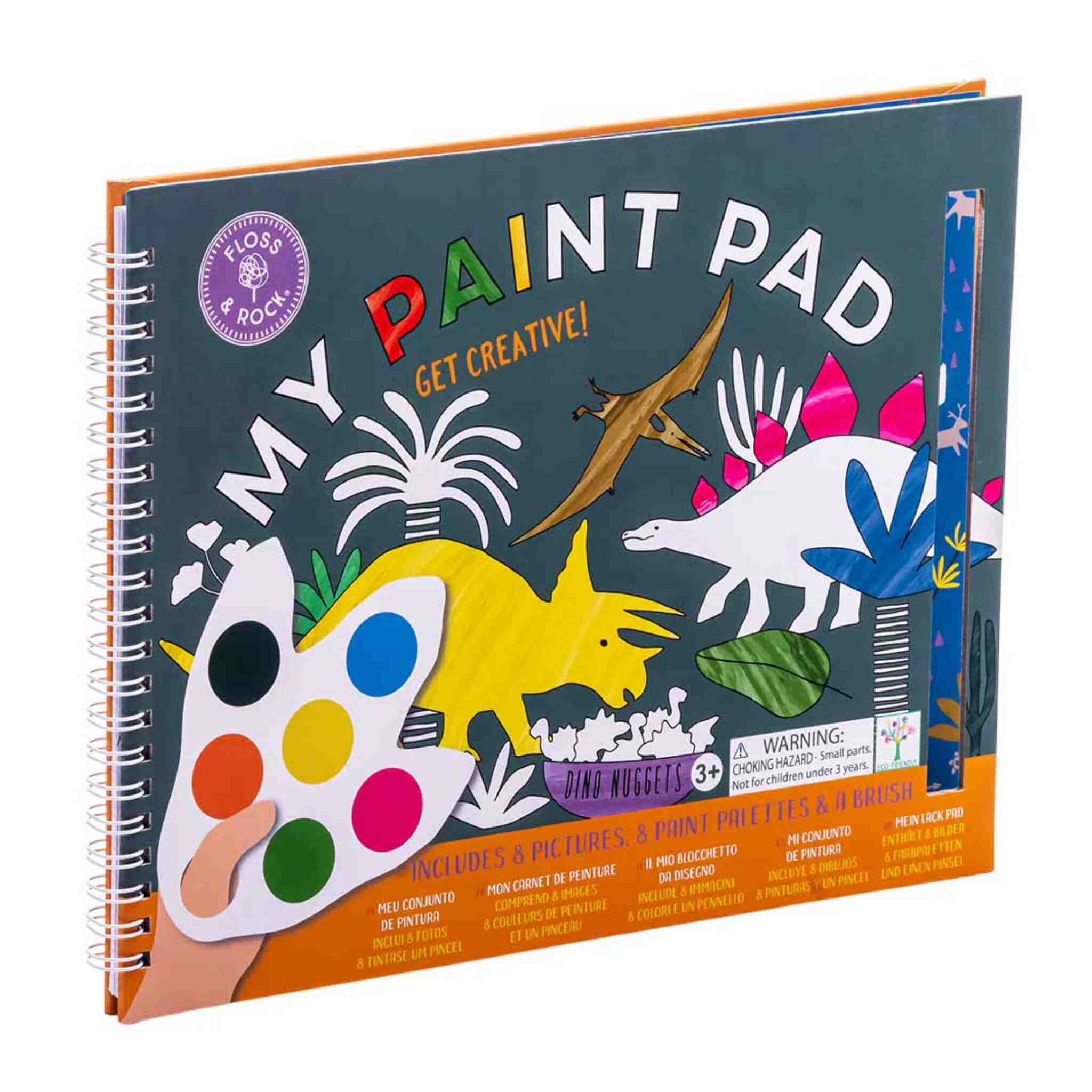 Cover of a spiral-bound children's painting book titled "Dino My Painting Pad" by Floss & Rock. This cover features vibrant dinosaurs, dinosaur foot-shaped paint palettes, and plants. Includes a warning suitable for ages 3 and up. Tear-out pictures are designed to inspire creativity.