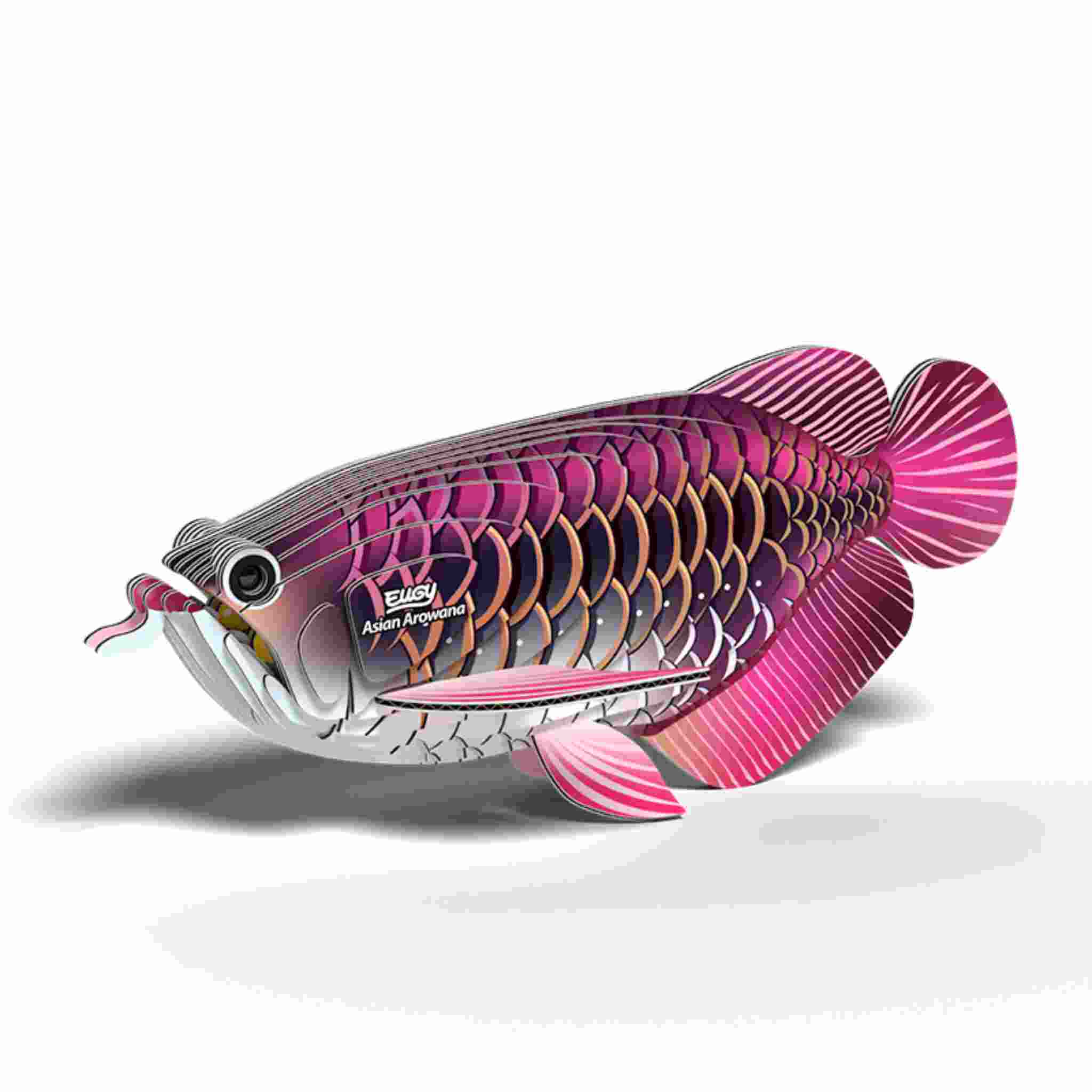 The EUGY Asian Arowana is a colorful fish sculpture with intricate pink and purple scales, featuring a tongue-like object from its mouth. The stylized design mimics Eugy figures and casts a shadow on a white background.