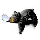 A stylized, striped Eugy Black Bear puzzle by EUGY is playfully blowing a shiny, colorful bubble while lying down. "Eugy Black Bear" appears on its side, set against a white background—ideal for educational decor.