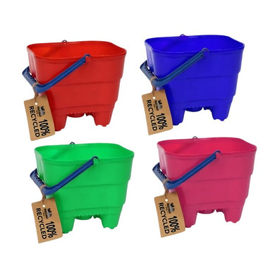 Four rectangular, rounded-corner Eco 100% Recycled Castle Buckets by Crazy Coast are shown in red, blue, green, and pink. Designed as eco-friendly children's products, each bucket features a blue handle and a "100% Recycled" tag to emphasize their sustainable material.