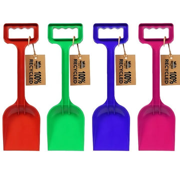 Four Crazy Coast "Eco 100% Recycled Spade – 12”" spades in red, green, blue, and pink are lined up. Each spade has a rectangular handle and is suitable for ages 3+, with a tag that reads "100% Recycled Materials.