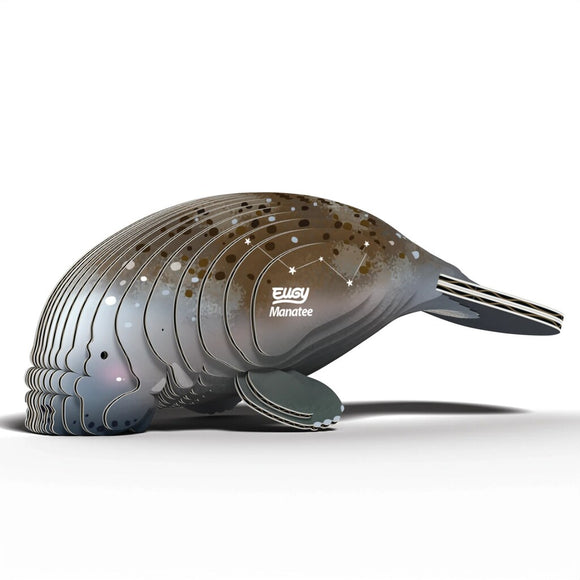 The EUGY Manatee is a decorative sculpture crafted from eco-friendly, layered panels in blue, brown, and white shades. It features star-like patterns and "Manatee" on the side, promoting ocean conservation.