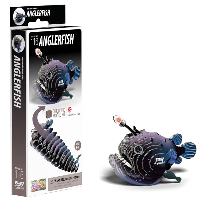 Box and finished model of EUGY Anglerfish cardstock kit. The packaging features the name "EUGY Anglerfish" and includes craft-yourself assembly instructions. The model showcases a dark blue anglerfish with a red-tipped lure. It is suitable for ages 6 and up, accompanied by a warning label.