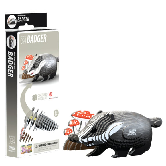 The EUGY Badger cardboard model kit highlights a delightful black and white badger made from sustainable materials, with mushrooms depicted on the packaging. After assembly, this EUGY toy figure stands proudly next to its box, which displays construction steps and part number 094 with clear labeling.