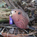 The EUGY Eugy Beaver is a collectible, eco-friendly paper-craft puzzle model featuring a beaver holding a purple notebook and sitting among twigs, leaves, and tree bark.