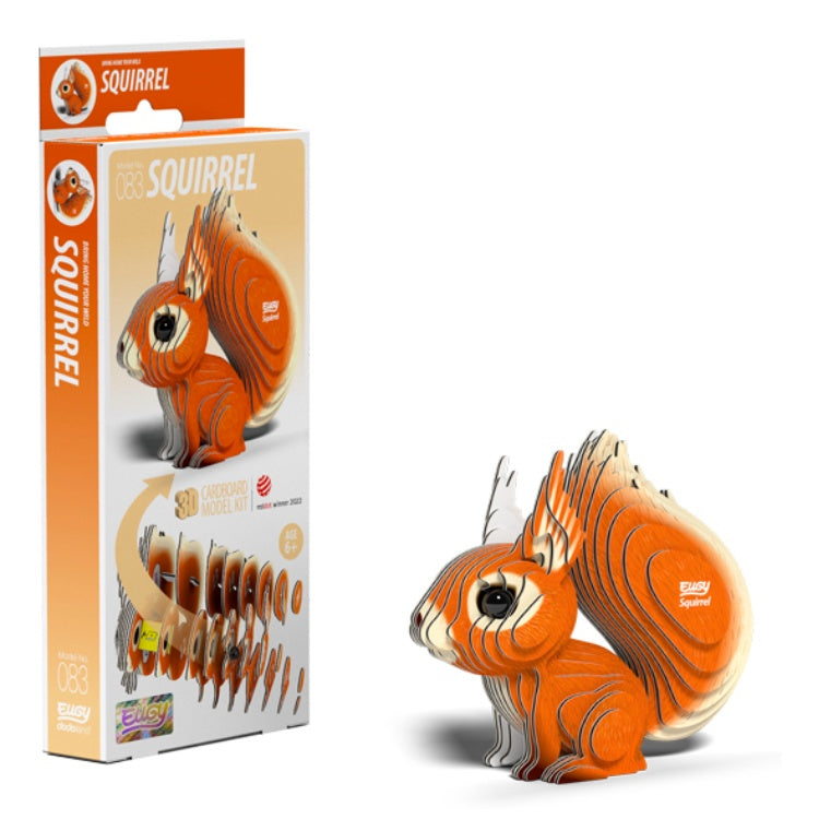 The image depicts a 3D cardboard model kit titled "EUGY Squirrel" by the brand EUGY, highlighting an eco-friendly design of an orange and white squirrel. The packaging is on the left, accompanied by the assembled red squirrel toy figure on the right.