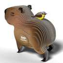 The EUGY Capybara is a stylized, eco-friendly 3D puzzle model featuring illustrated lines and a small yellow and gray bird on its back, with "Capybara" and the EUGY logo on the side, making it an ideal gift for wildlife enthusiasts.