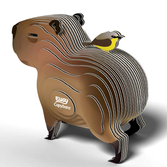 The EUGY Capybara is a stylized, eco-friendly 3D puzzle model featuring illustrated lines and a small yellow and gray bird on its back, with "Capybara" and the EUGY logo on the side, making it an ideal gift for wildlife enthusiasts.