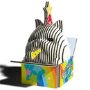 A vibrant, eco-friendly cardboard display shaped like the Eugy Cottonball Cat from EUGY, featuring a cute round cat with party hat and star, emerging from a "Party Pack!! Deluxe!" box with rainbow and star designs.