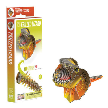 A 3D cardboard model kit called the EUGY Frilled Lizard, made from environmentally-friendly materials, is on display. The EUGY kit box, featuring vivid graphics of the frilled lizard, stands upright next to the assembled model which highlights intricate frills and a vibrant design, ideal for collectible crafts.