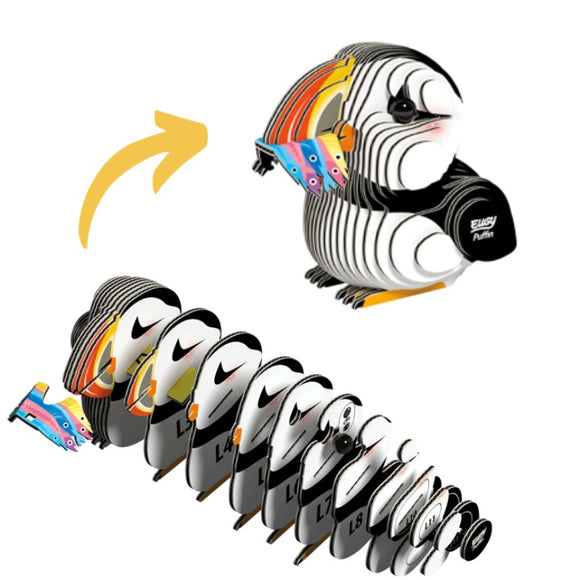 The EUGY Puffin, by the brand EUGY, is an eco-friendly sculpture crafted from sustainable, colorful wooden layers. The separate layers are displayed at the bottom, leading up to the finished Puffin at the top. An arrow illustrates the transformation from individual pieces to a complete sculpture.