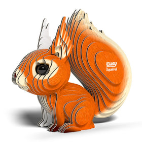 A stylized, layered model of an orange and cream red squirrel with a large bushy tail, featuring the words "EUGY Squirrel" on its side, rests on a white surface. This eco-friendly design from EUGY combines intricate lines with a 3D effect.