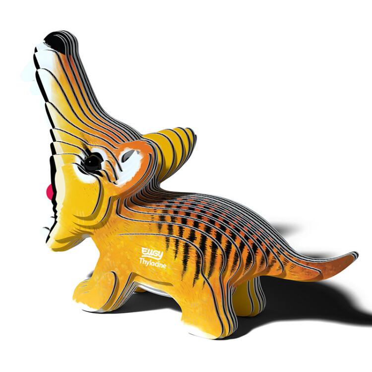 A vibrant, cartoon-style EUGY Tasmanian Tiger model displays stripes and a playful design. The eco-friendly figure is layered, showcasing the word "Thylacine" and the EUGY brand logo on its body. Its open mouth reveals the tongue.