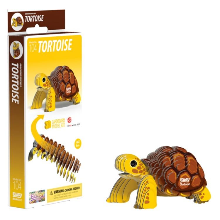 Introducing the EUGY Tortoise, a 3D cardboard model kit designed for ages 6 and up. This eco-friendly product by EUGY features yellow and brown parts that come together to form a realistic tortoise. The packaging highlights the final model along with step-by-step assembly instructions, emphasizing its simplicity as an easy DIY project.