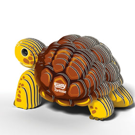 Introducing the EUGY Tortoise by EUGY, a stylized tortoise toy characterized by its yellow and brown segmented shell. Made from eco-friendly materials, it features "EUGY Tortoise" written on the geometric-patterned shell with a smooth, shiny surface that highlights an artistic and playful aesthetic.