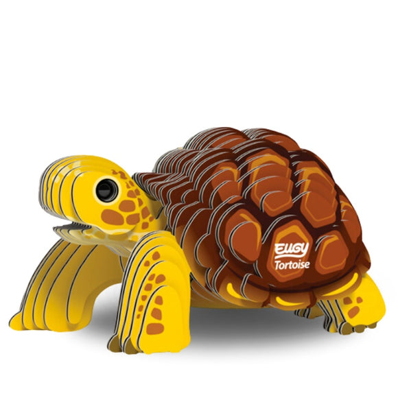 The EUGY Tortoise is a 3D puzzle model crafted from eco-friendly materials, showcasing a cartoonish design with yellow and brown sections. "EUGY Tortoise" is printed on its shell, and it features striped patterns on its body along with large, expressive eyes that enhance its charming appeal.