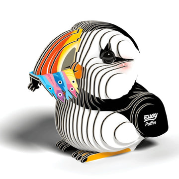 Introducing the EUGY Puffin, a vibrant 3D puzzle model crafted from eco-friendly materials. This charming creation features layered pieces that form a cartoonish design, complete with a puffin holding colorful fish in its beak. As an extra detail of delight, "EUGY Puffin" is elegantly printed on its wing.