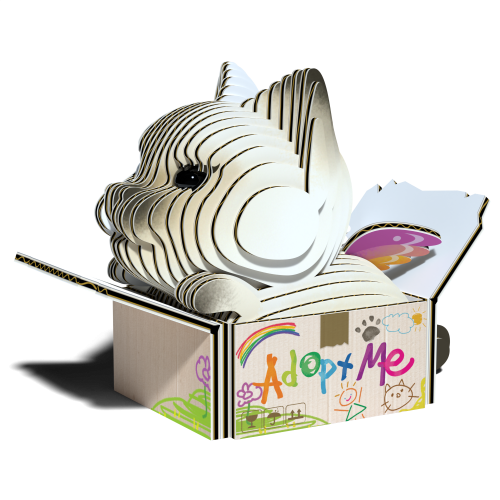 The EUGY Eugy Cat - Mocha, an environmentally-friendly cardboard cat-shaped sculpture, is showcased inside an open box. The packaging is adorned with colorful illustrations, including the words "Adopt Me" alongside drawings of a rainbow, flowers, and paw prints, highlighting creative excellence.