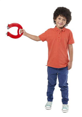 A young boy with curly hair stands smiling, wearing an orange polo shirt and blue pants. He proudly holds the BRAINSTORM TOYS "Massive Magnet," showcasing the wonders of STEM toys and magnetism against a plain white background.