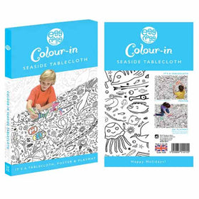 The "eggnogg Giant Poster / Tablecloth – Seaside" packaging displays a child coloring an ocean-themed design. Versatile as a seaside poster, playmat, or party centerpiece with "Happy Holidays!" text, it's ideal for children's parties.