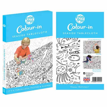 The "eggnogg Giant Poster / Tablecloth – Seaside" packaging displays a child coloring an ocean-themed design. Versatile as a seaside poster, playmat, or party centerpiece with "Happy Holidays!" text, it's ideal for children's parties.