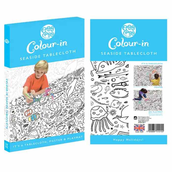 The "eggnogg Giant Poster / Tablecloth – Seaside" packaging displays a child coloring an ocean-themed design. Versatile as a seaside poster, playmat, or party centerpiece with "Happy Holidays!" text, it's ideal for children's parties.