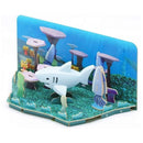 The Halftoys Diorama - White Shark by Halftoys is a 3D paper model featuring a white shark, colorful fish, coral, and sea plants—ideal for sea animal playsets or educational STEM toys in a vivid blue ocean backdrop.