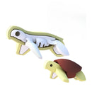 Two figures from the Halftoys Diorama - Green Turtle by Halftoys are shown: one pale yellow and cut open to display white bones, the other with a brown shell. Both have simple, cartoon-style designs on a white background.