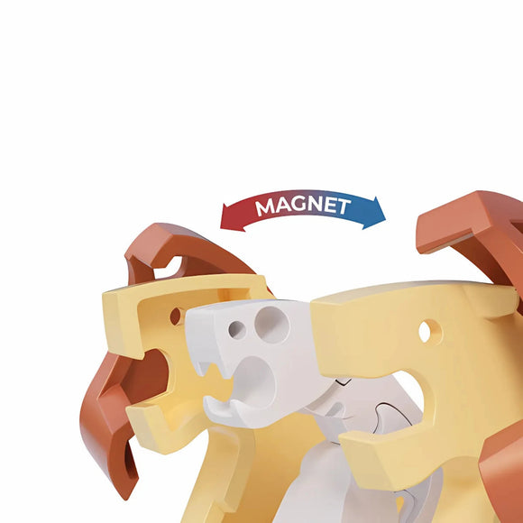 Two stylized plastic animal heads, one brown and one yellow, face each other with a white section in between on the Halftoys Diorama - Lion by Halftoys. An arrow labeled "MAGNET" curves above, showing magnetic attraction—great for animal-themed playsets.