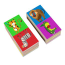 Two stacks of colorful Into the Wild Animal Dominoes cards are shown; left features a tiger playing cricket and a zebra, while right has a mandrill and an alligator with a hat. Each card boasts vibrant backgrounds ideal for enhancing matching skills in this Into the Wild product.