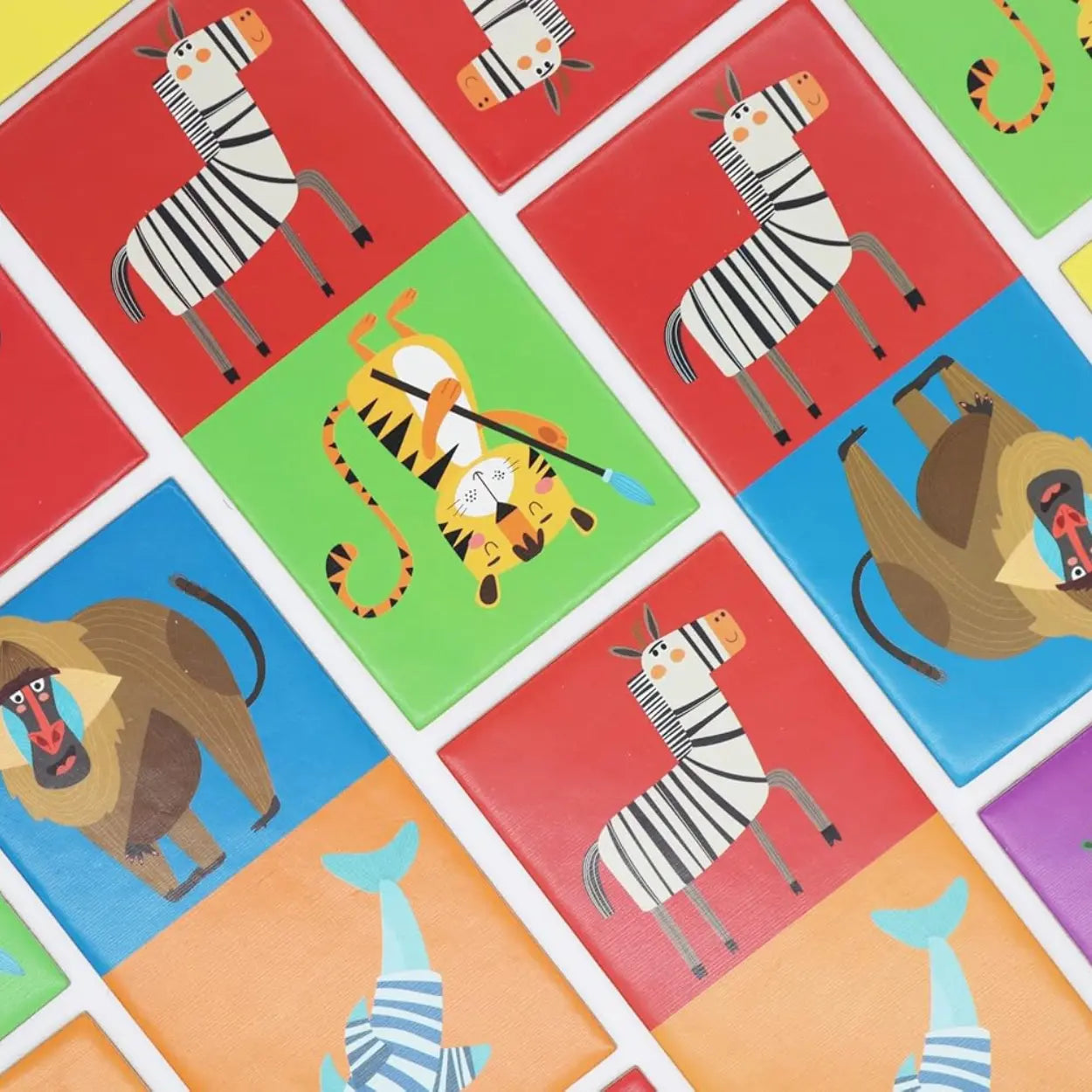 A grid of vibrant cards from "Into the Wild Animal Dominoes" by Into the Wild showcases playful animal illustrations like zebras on red and tigers on green. Improve your matching skills with cartoon-style baboons and dolphins set against vivid backdrops.