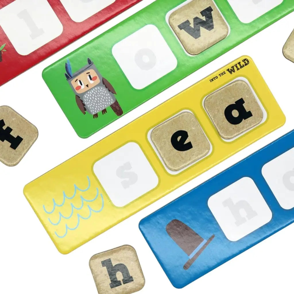 The Into the Wild Seek & Spell game by Into the Wild features vibrant boards and letter tiles, with images like an owl in a hat and waves. Letters "f" and "h" appear on green, yellow, and blue backgrounds. Perfect for exciting pre-school activities!.