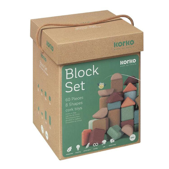 A brown cardboard box with a handle features "Giant Architects" and "60 Cork Building Blocks" by Korko. The image shows colorful blocks stacked in a tower, ideal for enhancing fine motor skills and promoting eco-friendly play.