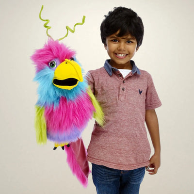 Child holding a colourful plush Bird of Paradise hand puppet against a plain background