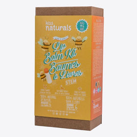 The KISS NATURALS DIY Natural Lip Balm Kit comes in a vibrant box adorned with illustrations of bees, honey, and ingredients. It features bilingual English and French text, is suitable for ages 6 and up, contains non-toxic ingredients, and is labeled as 100% natural.