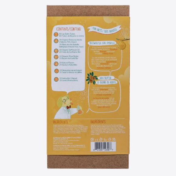 The cardboard packaging of the KISS NATURALS DIY Natural Lip Balm Kit lists its contents and non-toxic ingredients in both English and French. It boasts colorful illustrations, including a cartoon character holding a honey jar, with a bee and honeycomb pattern design element, making it perfect for your DIY project.